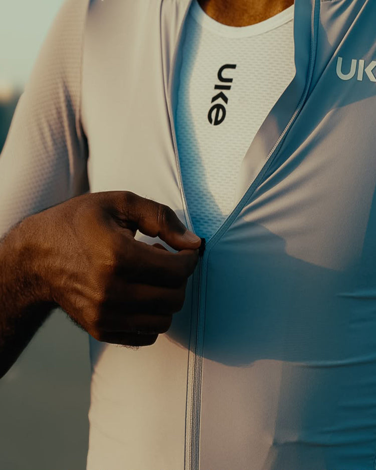 Cyclist layering a jersey over a base layer